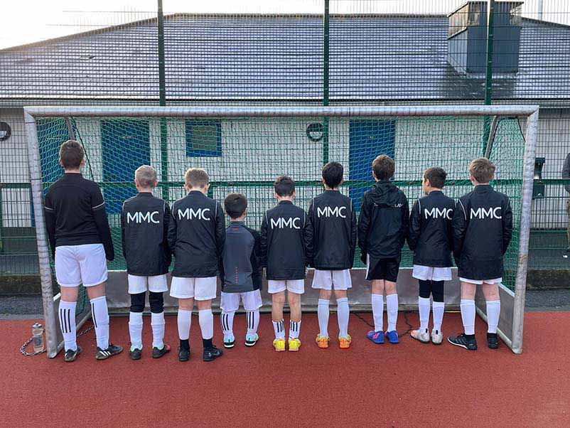 Under 12 Corinthian's football team in their MMC jackets